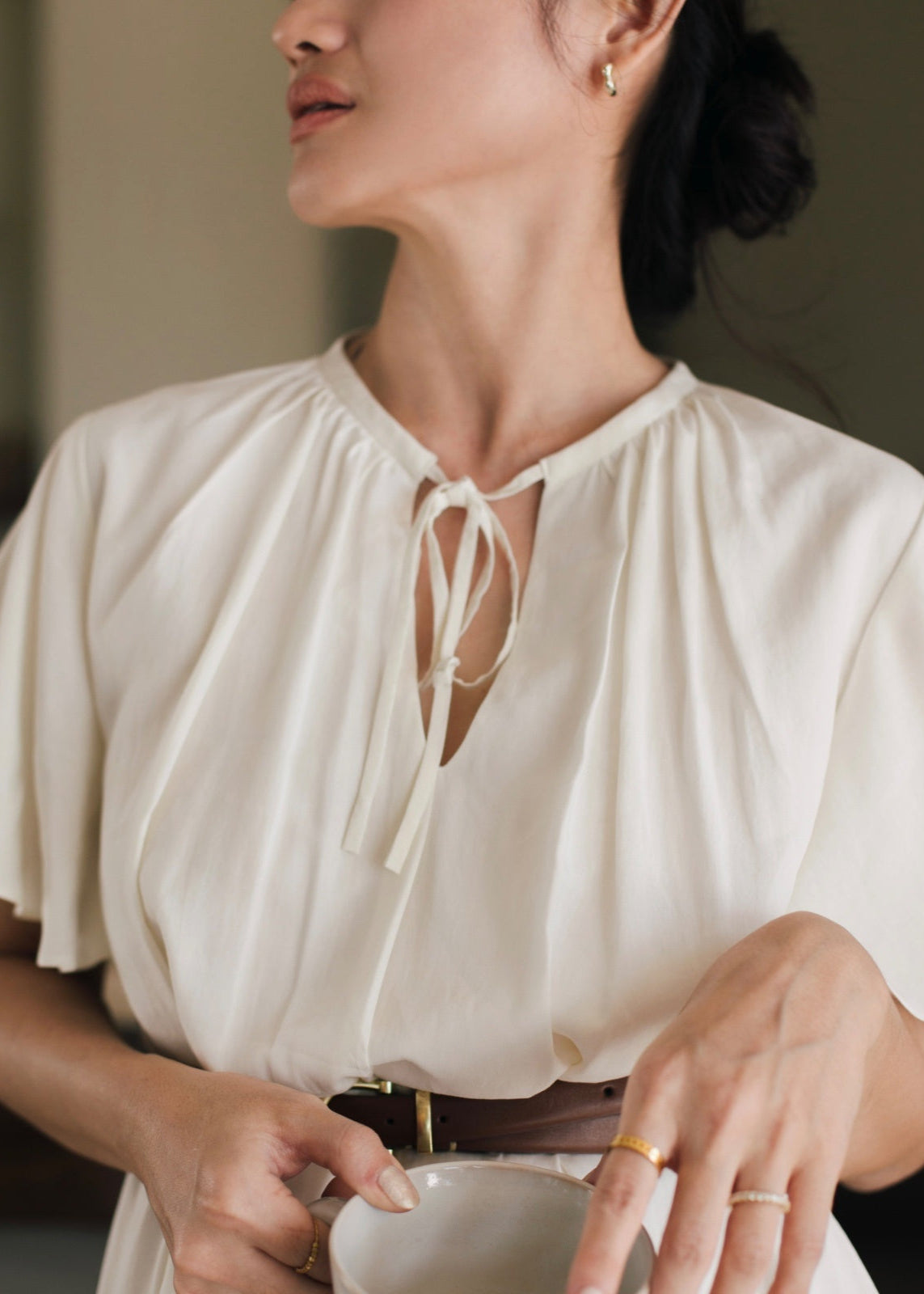 Woman wearing a white blouse with a blurred background