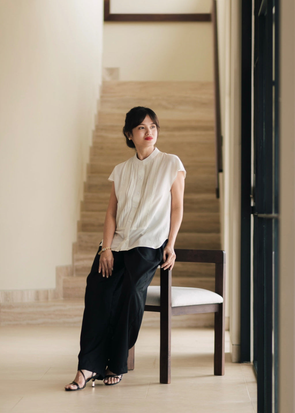 Woman sitting on a chair in a modern interior setting